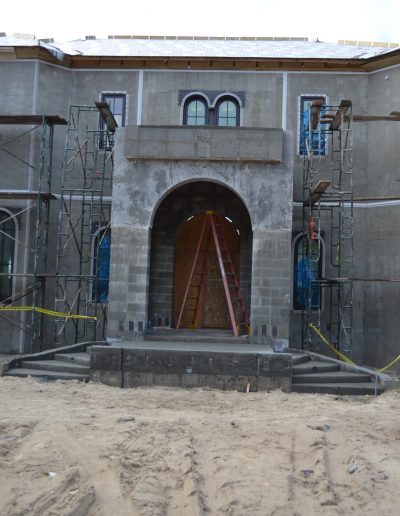 the arched entrance to a building, crated with concrete blocks