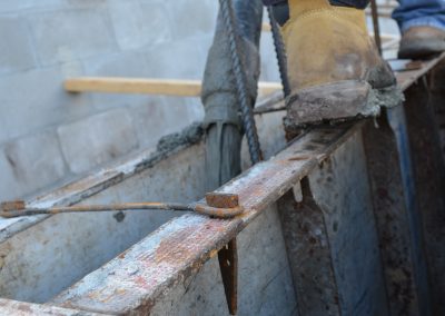 workers stand on support beams