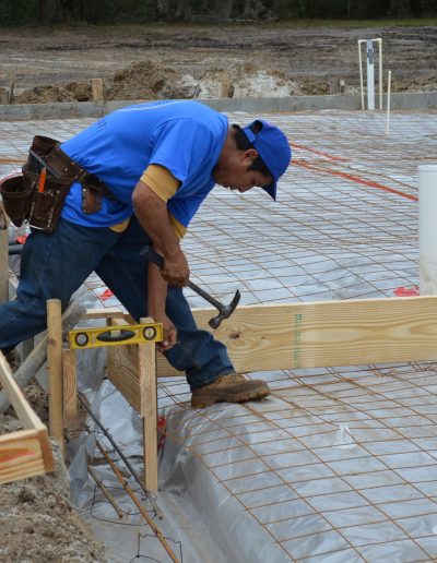 a worker swings a hammer