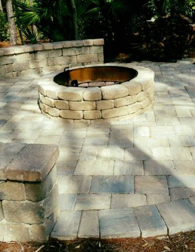 a fire pit built by Walker Footings surrounded on one side by a curved bench