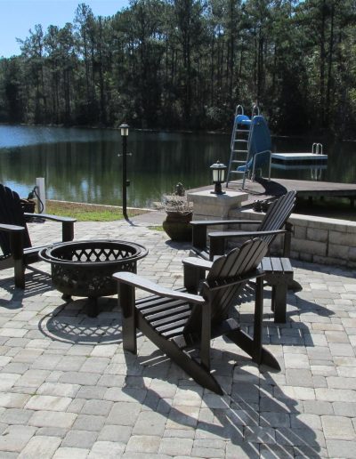 curved patio by a river, with a seatwall on one side