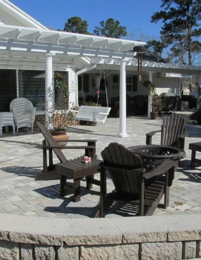 unique patio, covered in part by a pergola, with a seatwall on one side