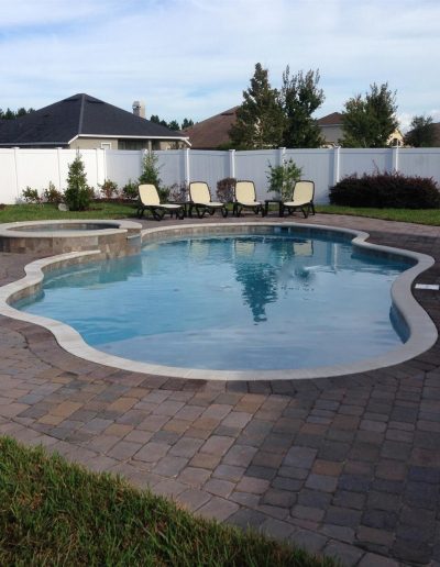 pool deck with a hot tub