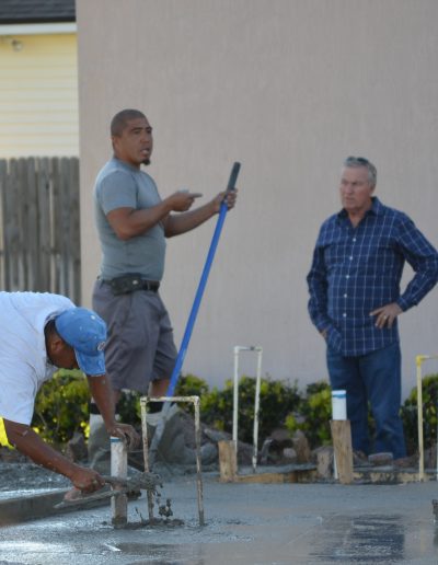 three workers discuss a project while they work