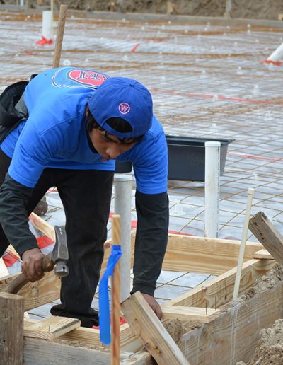 a worker swings a hammer