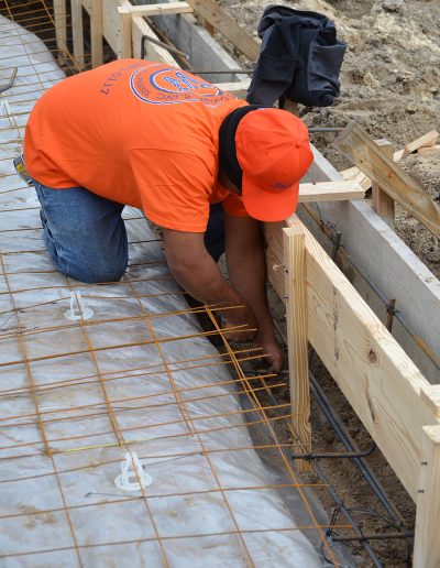 a man working on a concrete footing