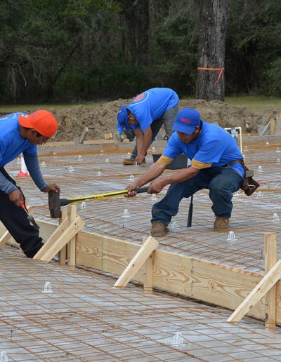 several workers working on a concrete footing