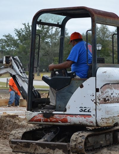 a worker operates a front loader on a job site