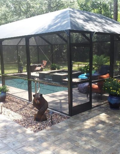 screened pool surrounded by pool deck and patio built by Walker Footings