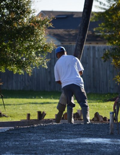 a Walker Footings worker pouring slab concrete