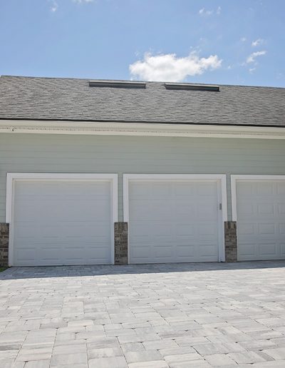 large driveway area outside house with a three car garage