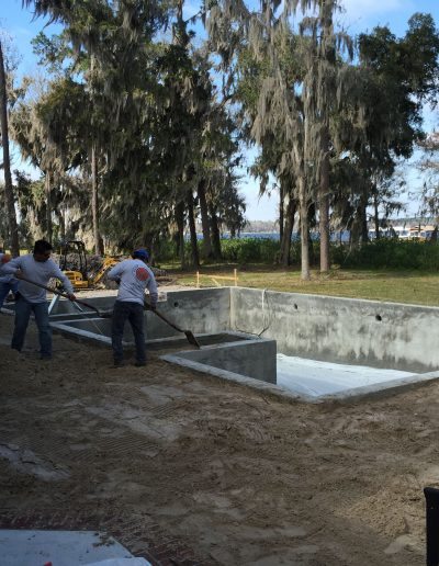 two men working on a concrete foundation